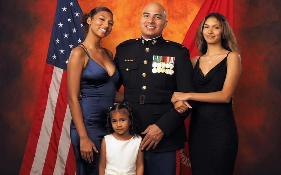 Chief Warrant Officer 4 Juan Arce, USMC, with his three daughters